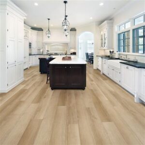 Modern kitchen with white cabinets, island, and wood flooring.